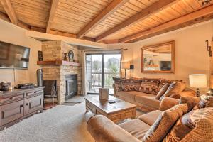 a living room with couches and a fireplace at Silverthorne Condo with Mountain Views Hike and Bike! in Silverthorne