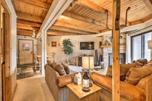 a living room with brown couches and a table at Ski and Hike Mtn-View Condo in Silverthorne! in Silverthorne