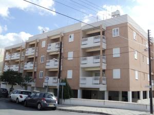 a building with cars parked in front of it at Lykavitos Apartments in Nicosia