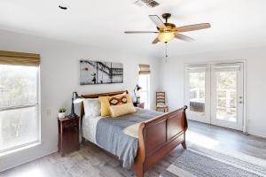 a bedroom with a bed and a ceiling fan at Guadalupe Oasis in Seguin
