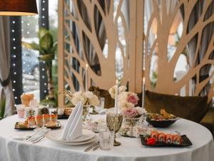 a white table with food and candles on it at Dream Hotel in Izmail