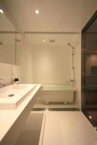 a bathroom with a sink and a bath tub at Studio-D in Tokyo