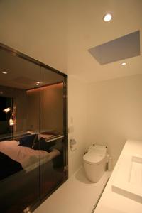 a bathroom with a bed and a toilet in it at Studio-D in Tokyo