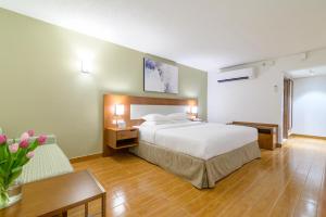 a hotel room with a bed, chair, and table at Dhafra Beach Hotel - Pet Friendly in Jebel Dhanna