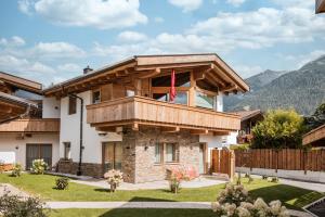 a house with a balcony on top of it at Löwen Chalets in Seefeld in Tirol