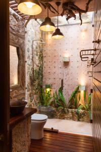 a bathroom with a shower with a toilet and plants at La Casa del Encomendero in Valladolid