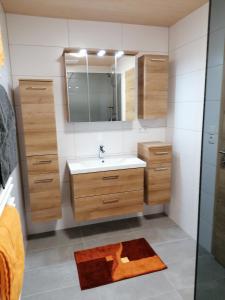 a bathroom with a sink and a mirror at Ferienwohnung Kirchler in Hippach