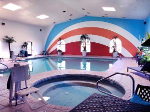 a large swimming pool with a red and blue wall at NavajoLand Inn in St. Michaels