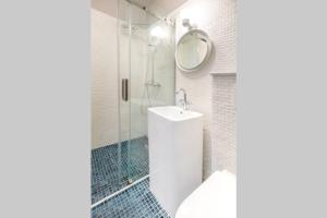 a white bathroom with a sink and a shower at Marvellous Design 2Br Old Town in Bucharest +17 photos