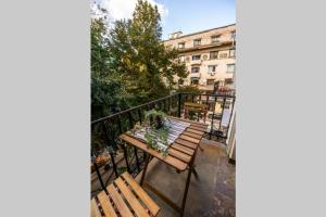 a balcony with a table and benches on a balcony at Marvellous Design 2Br Old Town in Bucharest