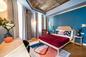 a bedroom with a bed and a blue wall at Marvellous Design 2Br Old Town in Bucharest