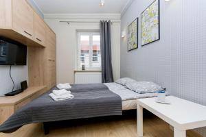 Posteľ alebo postele v izbe v ubytovaní RentApart Centrum