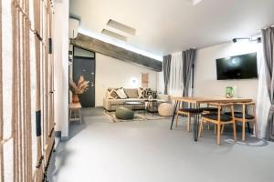 a living room with a table and a couch at Marvellous 2 Bedrooms Attic in the Old Town in Bucharest