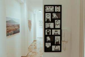 a wall with pictures of people in a room at SoStanza - Rooms in Catania in Catania