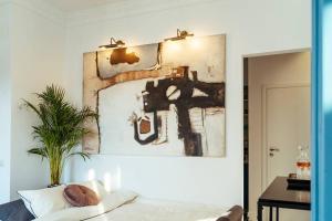 a bedroom with a painting on the wall next to a bed at Sunset Terrace in the Old Town in Bucharest