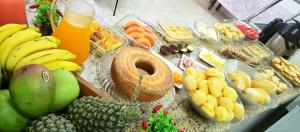 a table with a bunch of food and fruit on it at Infinity Hotel in Goiânia +71 photos