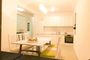 a kitchen and dining room with a table and chairs at Villa Una Sunset in Bihać