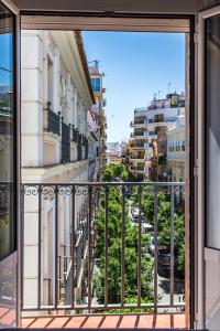a balcony with a view of a city at Hotel Madrid de Sevilla in Seville