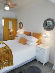 a bedroom with a large white bed and a table at Kingfisher 1 in Velddrif