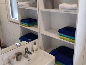 a bathroom with a sink and blue towels at Hofstadl Sonja Liebhart in Merkenbrechts