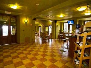 a lobby with a checkered floor and a restaurant at Apollo & SPA Karpacz in Karpacz