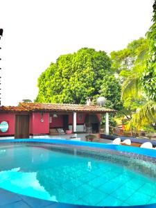 a swimming pool in front of a house at Pousada Coração do Arraial in Arraial d'Ajuda