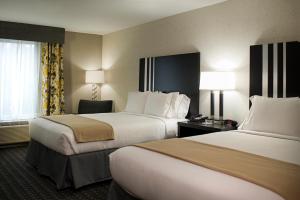 a hotel room with two beds and a window at Holiday Inn Express and Suites Madison Central, an IHG Hotel in Madison