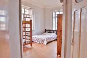 a bedroom with a bunk bed and a ladder at Vila Santa Eulalia Hostel in Pelotas