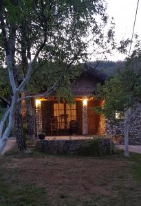 a stone house with lights on the front of it at COUNTRY HOUSE in Bihać