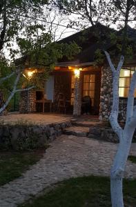 a house with a stone pathway leading to the front door at COUNTRY HOUSE in Bihać