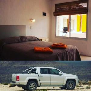 un camion blanc garé dans une chambre avec un lit dans l'établissement Desert Tracks Rancho, à Las Grutas