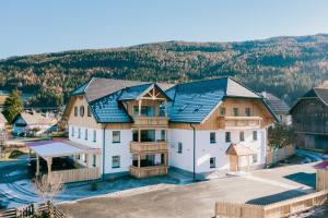 an aerial view of a large house with a roof at Landhaus Holzer in Sankt Margarethen im Lungau