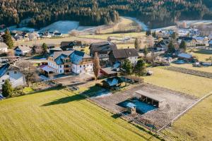 an aerial view of a house with a swimming pool at Landhaus Holzer in Sankt Margarethen im Lungau