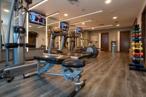a gym with treadmills and machines in a room at Hotel Ciudad de David in David
