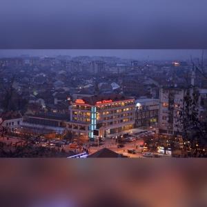 a view of a city at night at Theranda Hotel in Prizren