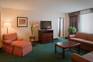 a hotel room with a living room with a television at Holiday Inn Arlington at Ballston by IHG in Arlington