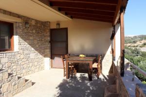 a table and chairs on the porch of a house at Amathianis in Triopetra +35 photos