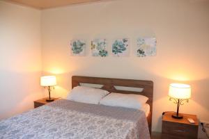 a bedroom with a bed and two lamps on tables at Amathianis in Triopetra