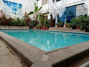 a swimming pool in front of a building at Hostal Sauna Water Palace in Quito