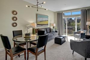 a living room with a table and a couch at City Water View Oasis with Pool & Gym near Cruise in Heart of Seattle in Seattle
