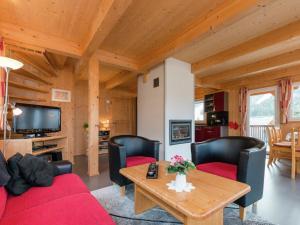a living room with a red couch and a table at Chalet in Hohentauern near ski area in Hohentauern