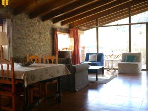 a living room with a table and chairs at Mas Franch in San Miguel de la Pineda