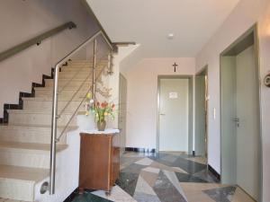 a staircase in a home with a cross on the wall at Traditional Holiday home in B tgenbach with Sauna in Butgenbach