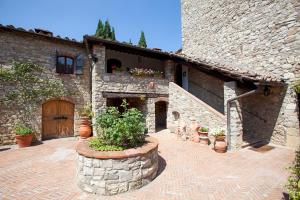 a stone building with a door and a patio at Nittardi in Castellina in Chianti