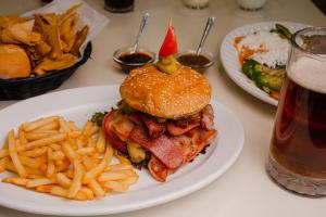 a plate of food with a sandwich and french fries at Hotel Palacio in C&oacute;rdoba