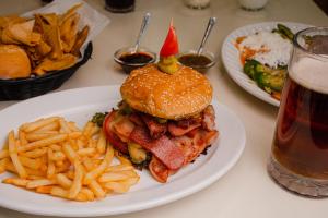 a plate of food with a sandwich and french fries at Hotel Palacio in Córdoba