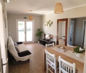 a dining room and living room with a table and chairs at CA NA CATALINA DEN ANDREU in Sant Francesc Xavier