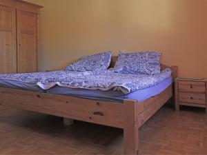 a bed with purple sheets and pillows in a bedroom at Modern Apartment in H ddingen with Terrace in Bad Wildungen
