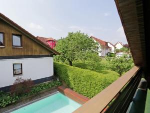 a view from the balcony of a house with a swimming pool at Apartment in Armsfeld with heated outdoor pool in Bergfreiheit