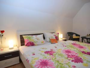 a bedroom with a bed with flowers on it at Ferienwohnung in Wehrstapel in Meschede